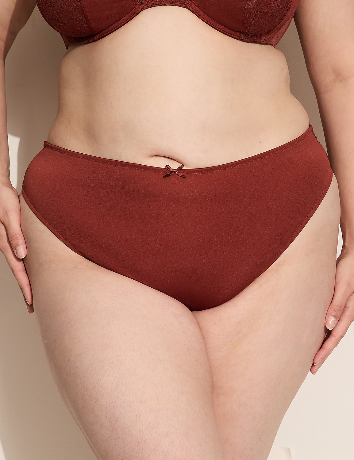 A person's torso is shown from the waist down, wearing rust-colored underwear and a matching bra, against a plain, light-colored background. Product Image 2