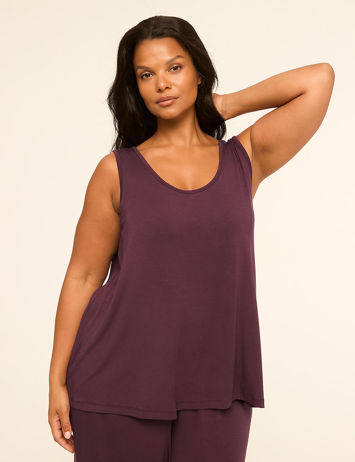 A woman in a purple tank top and pants poses against a plain, light-colored background. Product Image 4