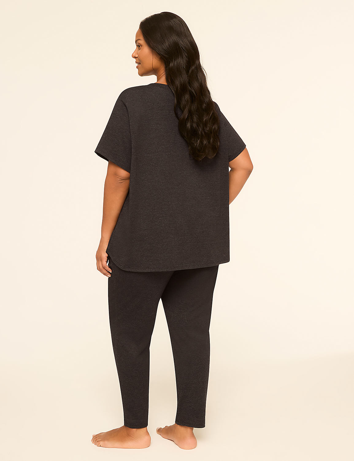 A woman in dark loungewear stands with her back to the viewer against a plain, light-colored background. Product Image 2