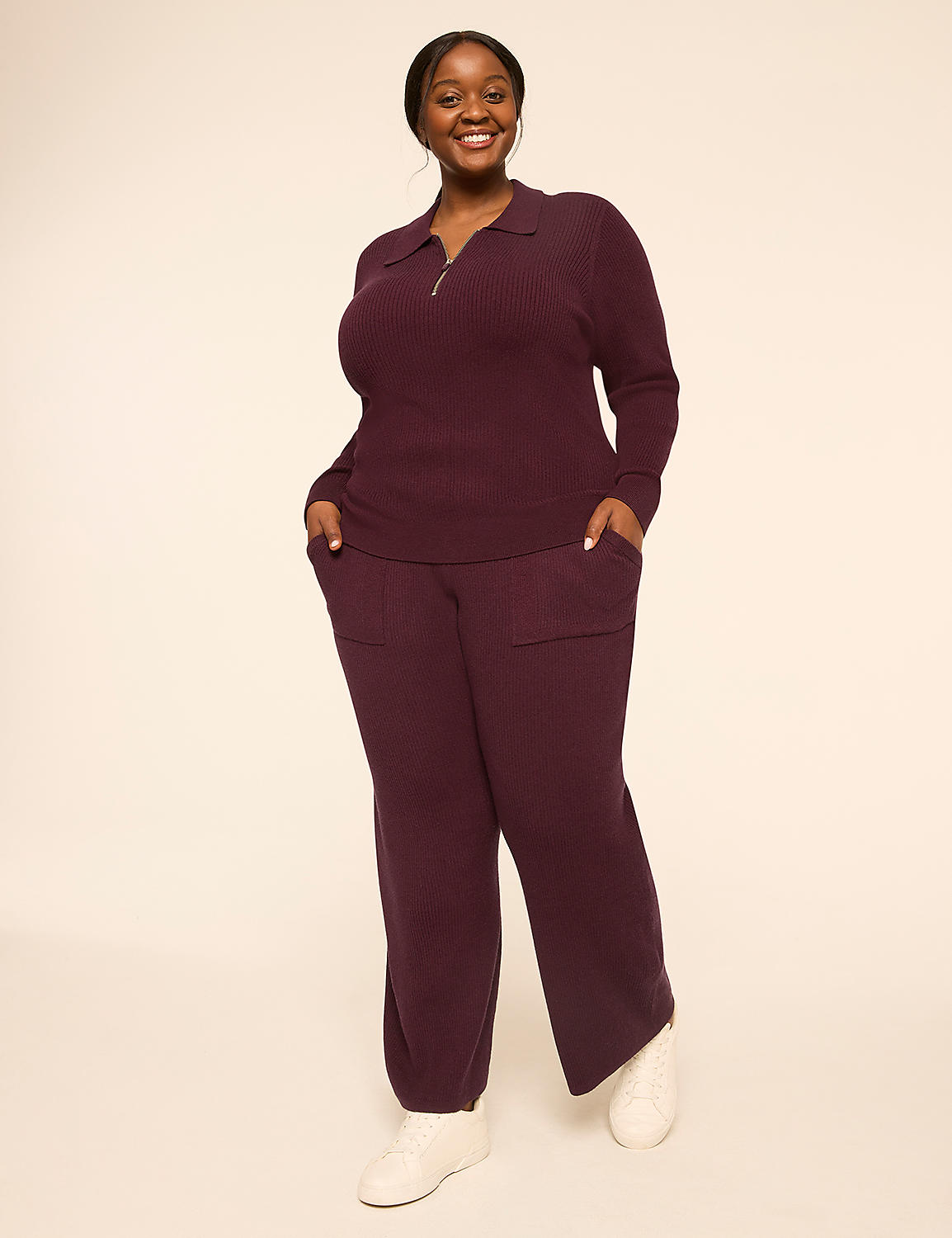 A smiling woman in a burgundy knit set stands with her hands in her pockets against a plain, light-colored background. Product Image 3