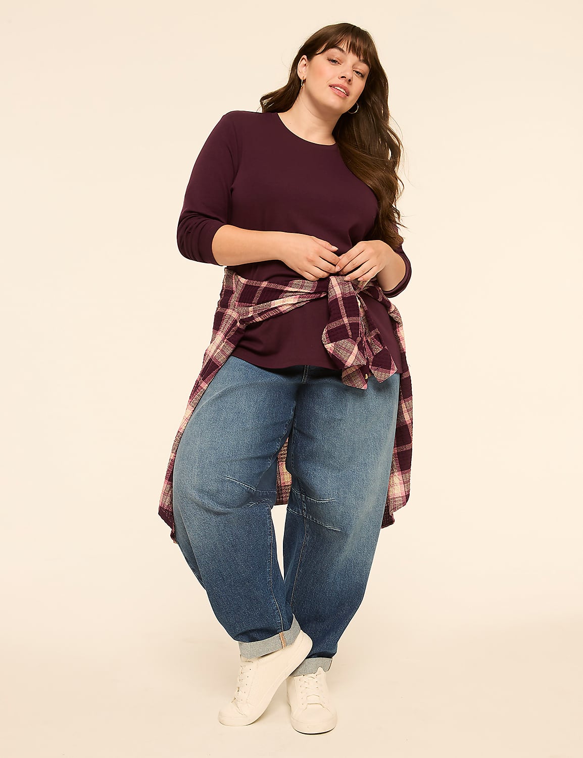 A woman in a burgundy shirt and baggy jeans stands against a plain, light-colored background. Product Image 3