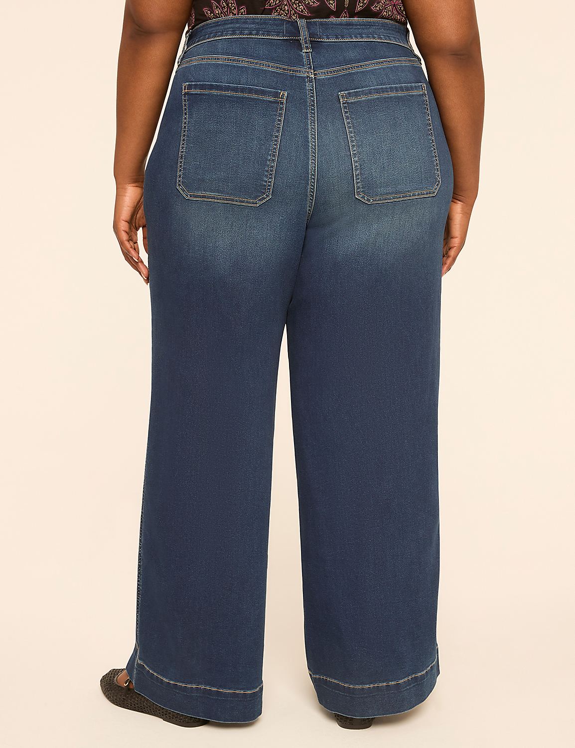 A person wearing wide-leg blue jeans stands against a plain, light-colored background. Product Image 2