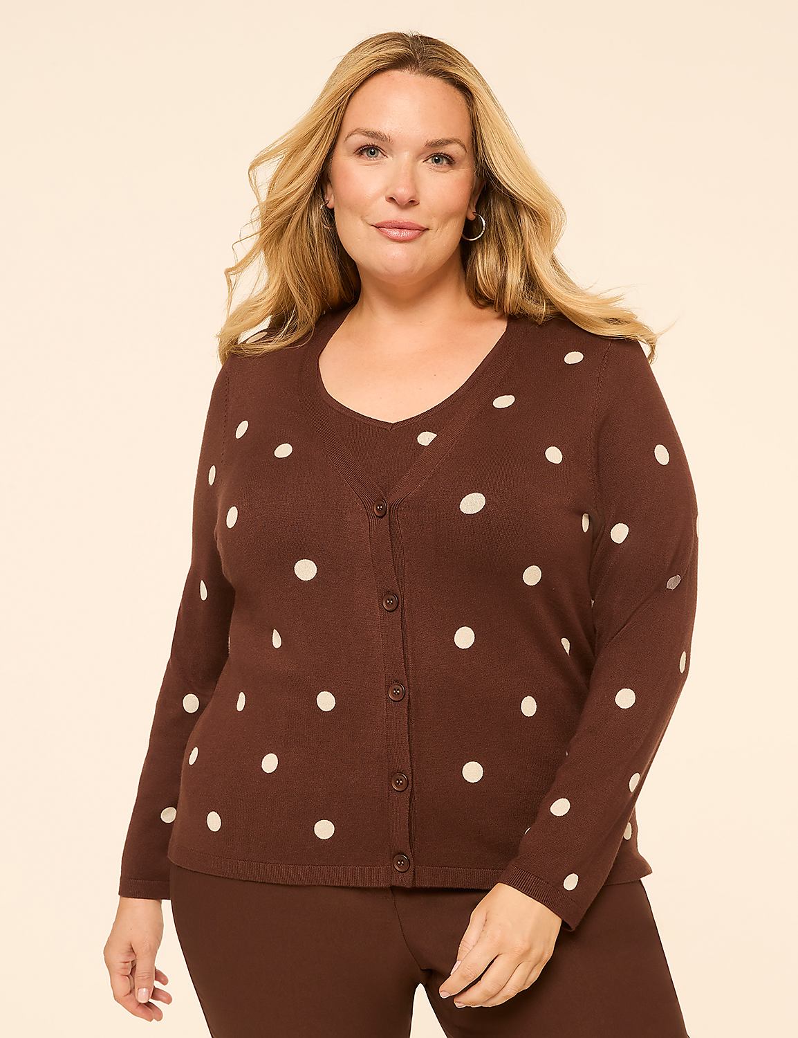 A woman in a brown polka dot cardigan and matching pants stands against a plain, light brown background. Product Image 1