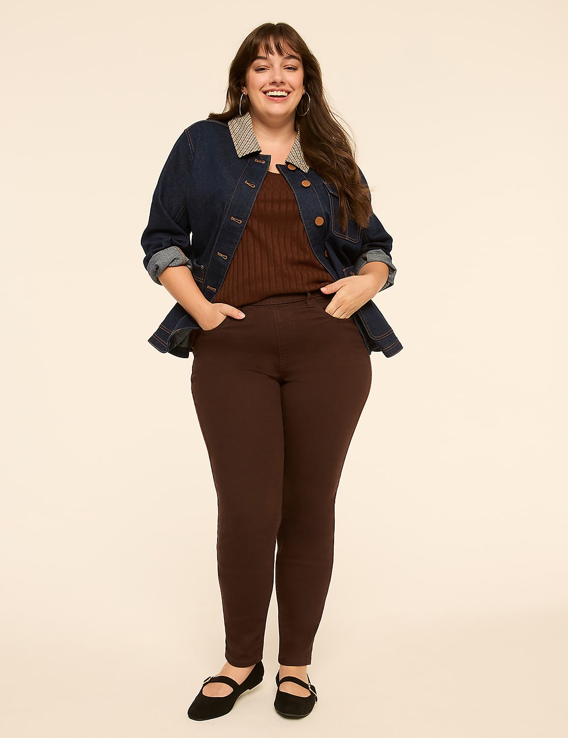 A smiling woman in a denim jacket and brown pants stands against a plain, light-colored background. Product Image 3