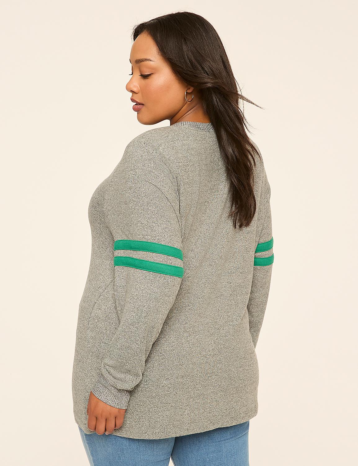 A woman in a grey sweater with green stripes on the sleeves stands against a plain, light-colored background. Product Image 2