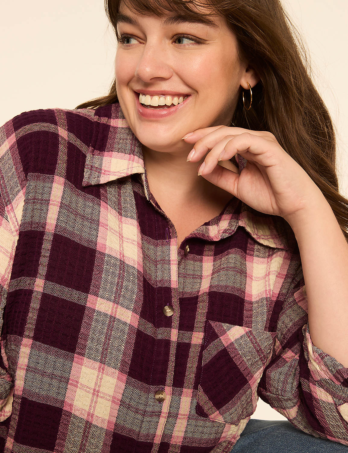 A smiling woman in a purple plaid shirt is captured against a plain, light-colored background. Product Image 4