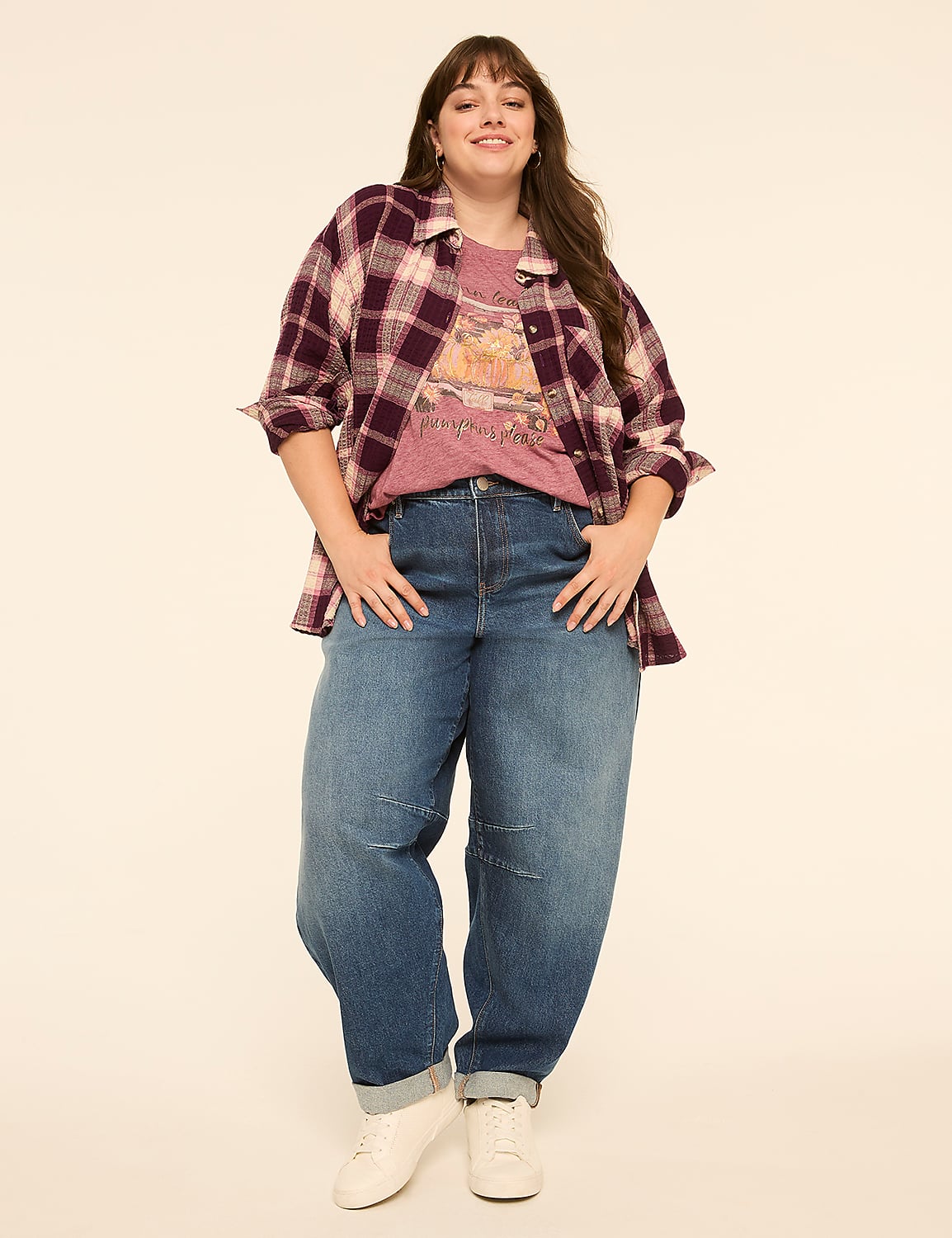 A smiling woman in a flannel shirt and jeans stands against a plain, light-colored background. Product Image 5