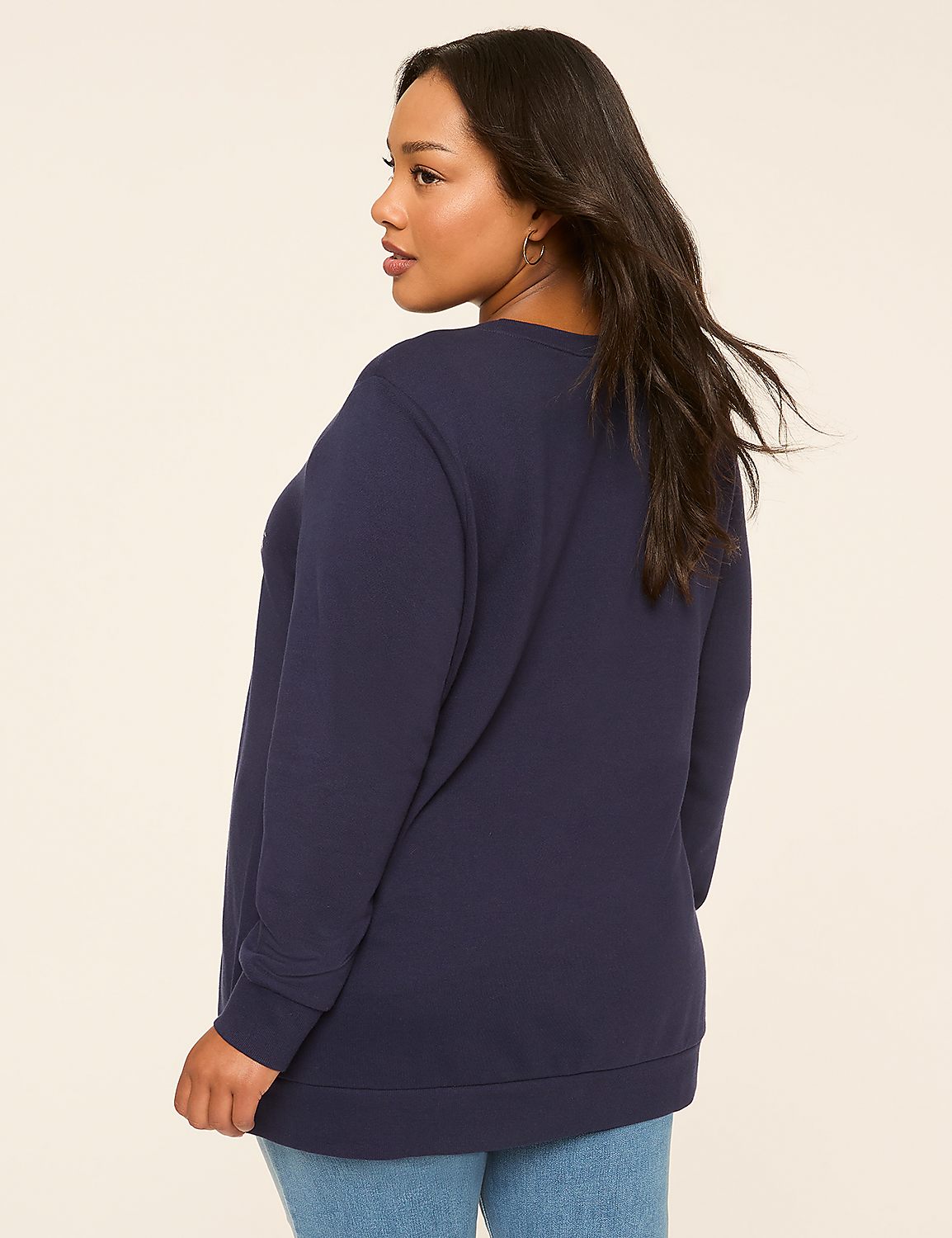 A woman in a navy sweatshirt and jeans stands against a plain, light-colored background. Product Image 2