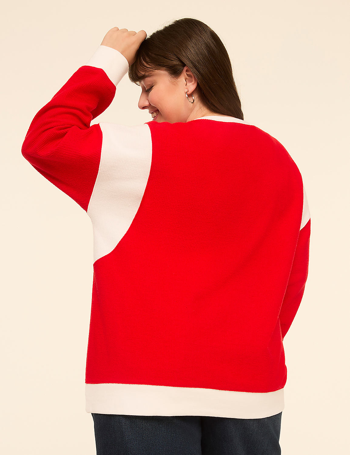 A woman in a red and white sweater stands with her back to the camera against a plain cream background. Product Image 2