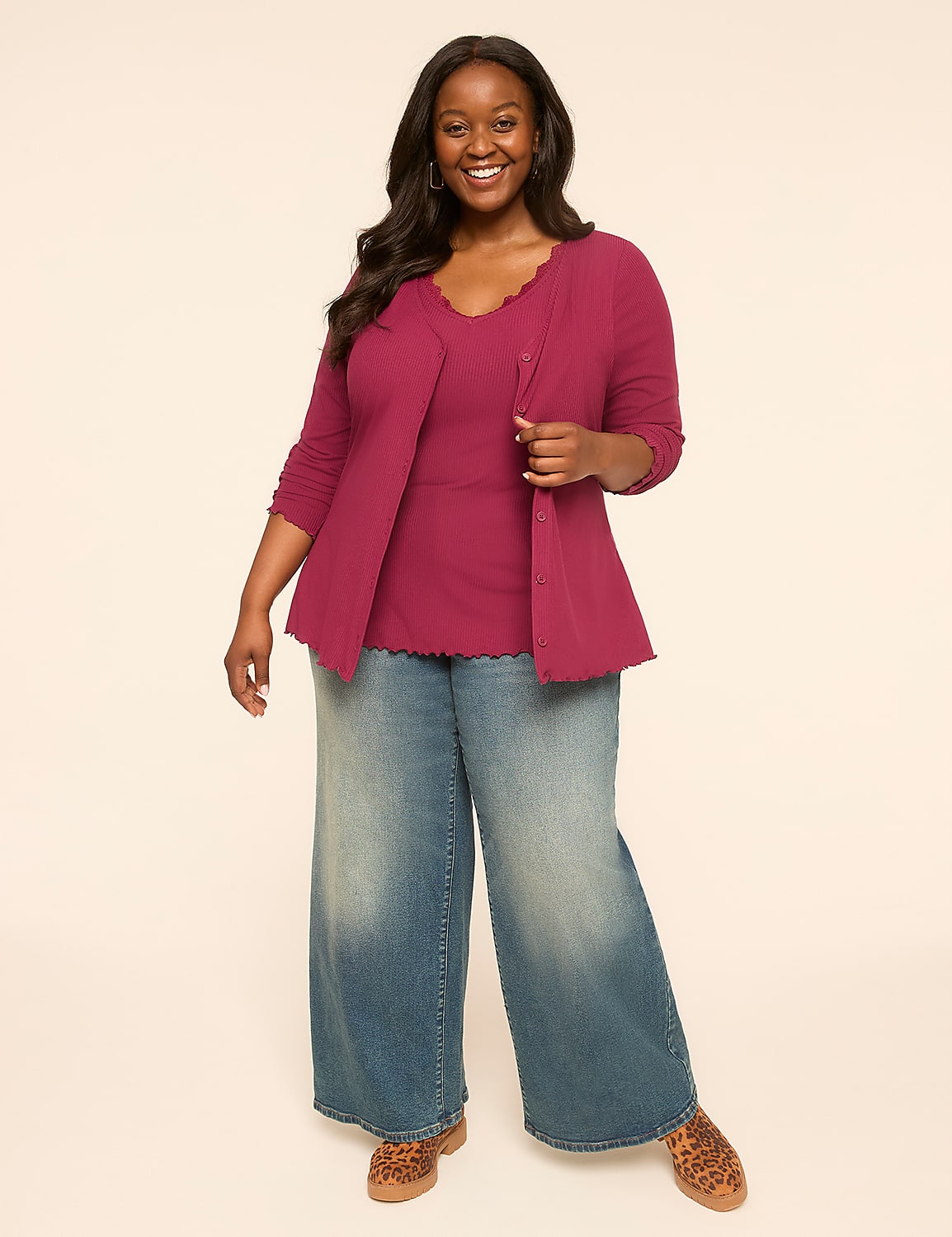 A smiling woman in a magenta cardigan and tank top stands in front of a plain, light-colored background. Product Image 3