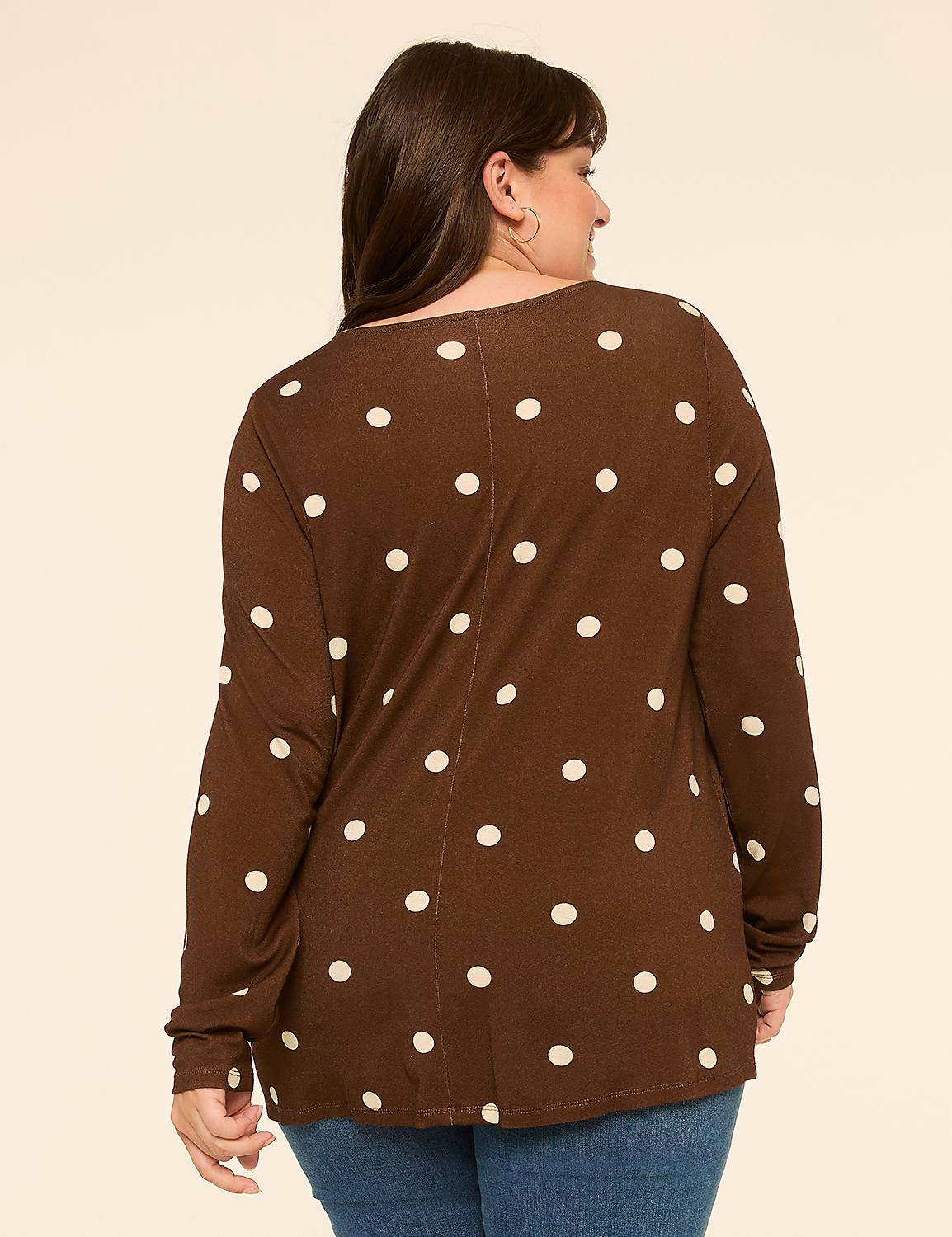 A woman in a brown polka dot shirt stands against a plain, light-colored background. Product Image 2