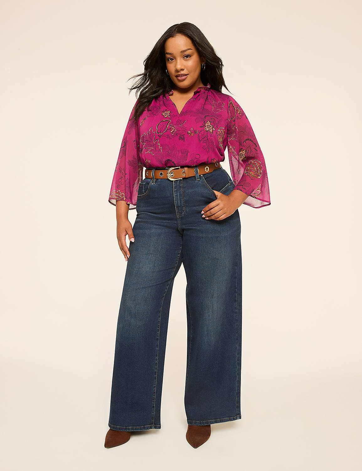A woman in a flowing magenta blouse and wide-leg jeans stands against a plain, light background. Product Image 4