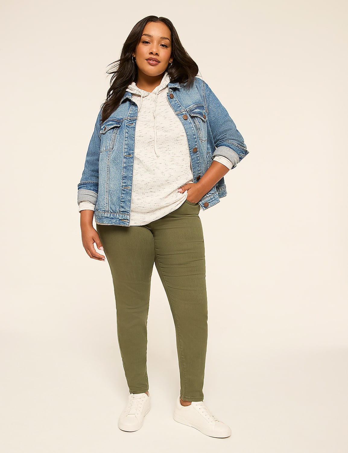 A woman in a denim jacket, hoodie, and olive green pants stands against a plain, light background. Product Image 3