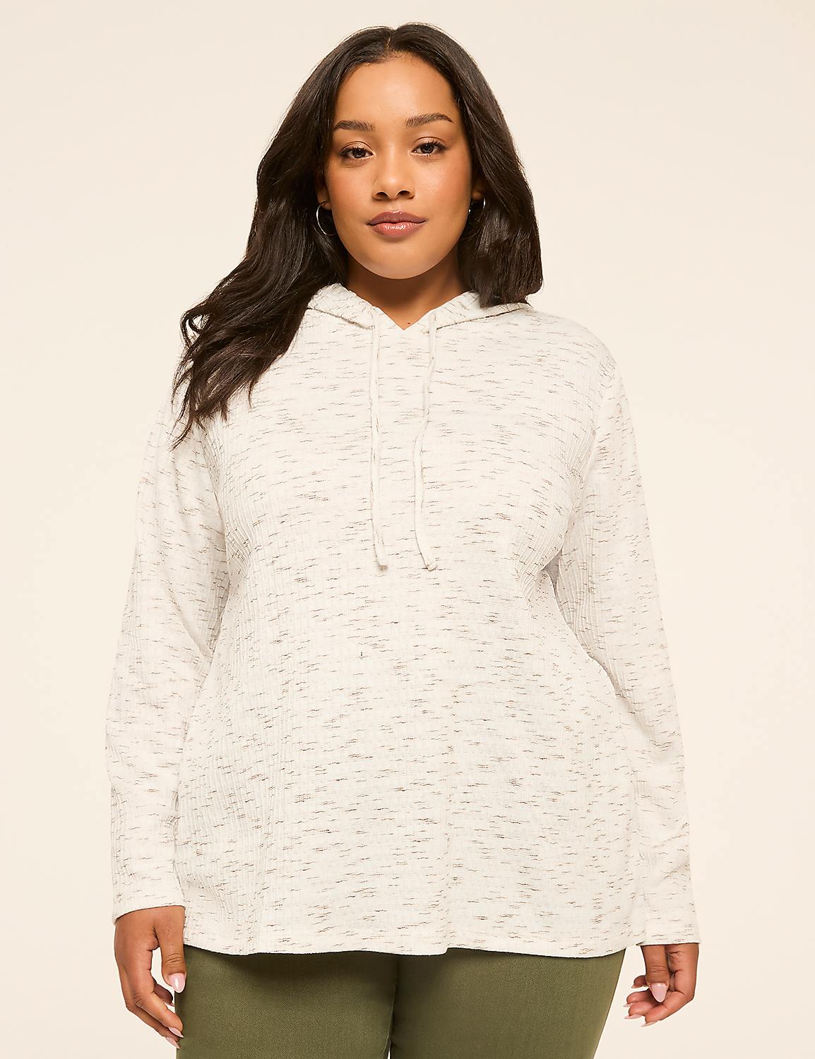 A woman in a speckled grey hoodie stands against a plain, light-colored background. Product Image 1