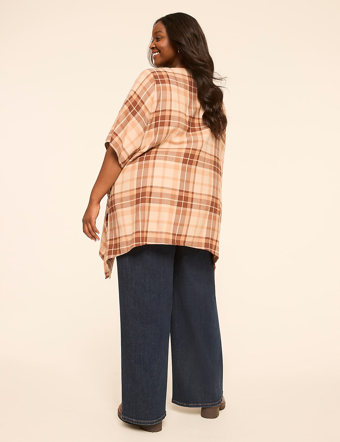 A woman in a plaid shirt and wide-leg jeans stands against a plain, light-colored background. Product Image 2