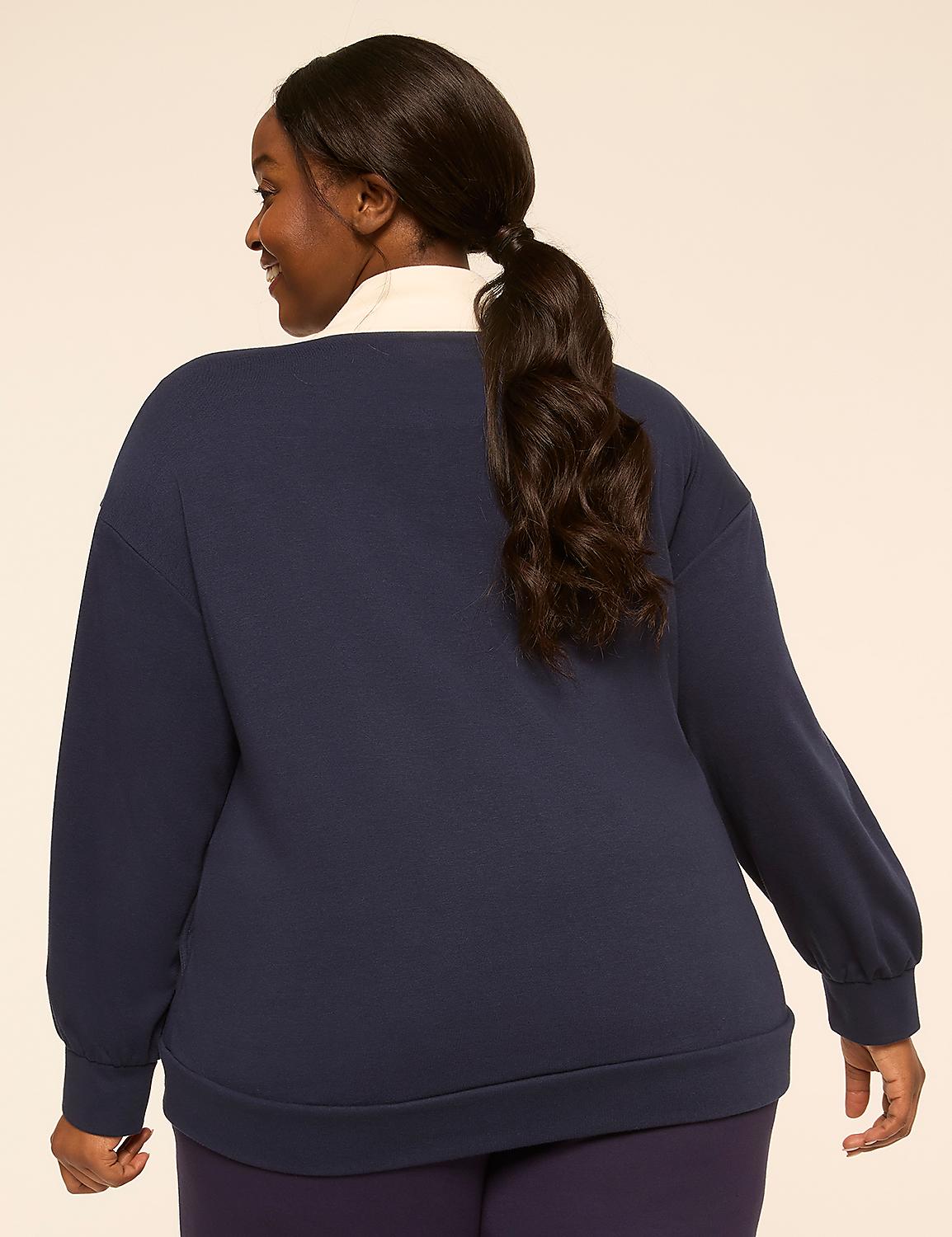 A woman with dark hair pulled into a ponytail, wearing a navy sweatshirt and dark leggings, stands against a plain, light-colored background. Product Image 2