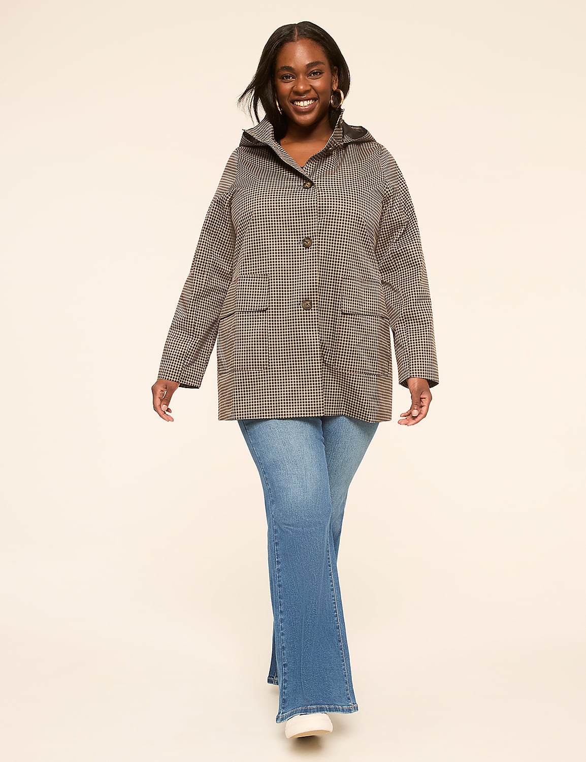 A smiling woman in a checkered jacket and flared jeans stands against a plain, light-colored background. Product Image 3