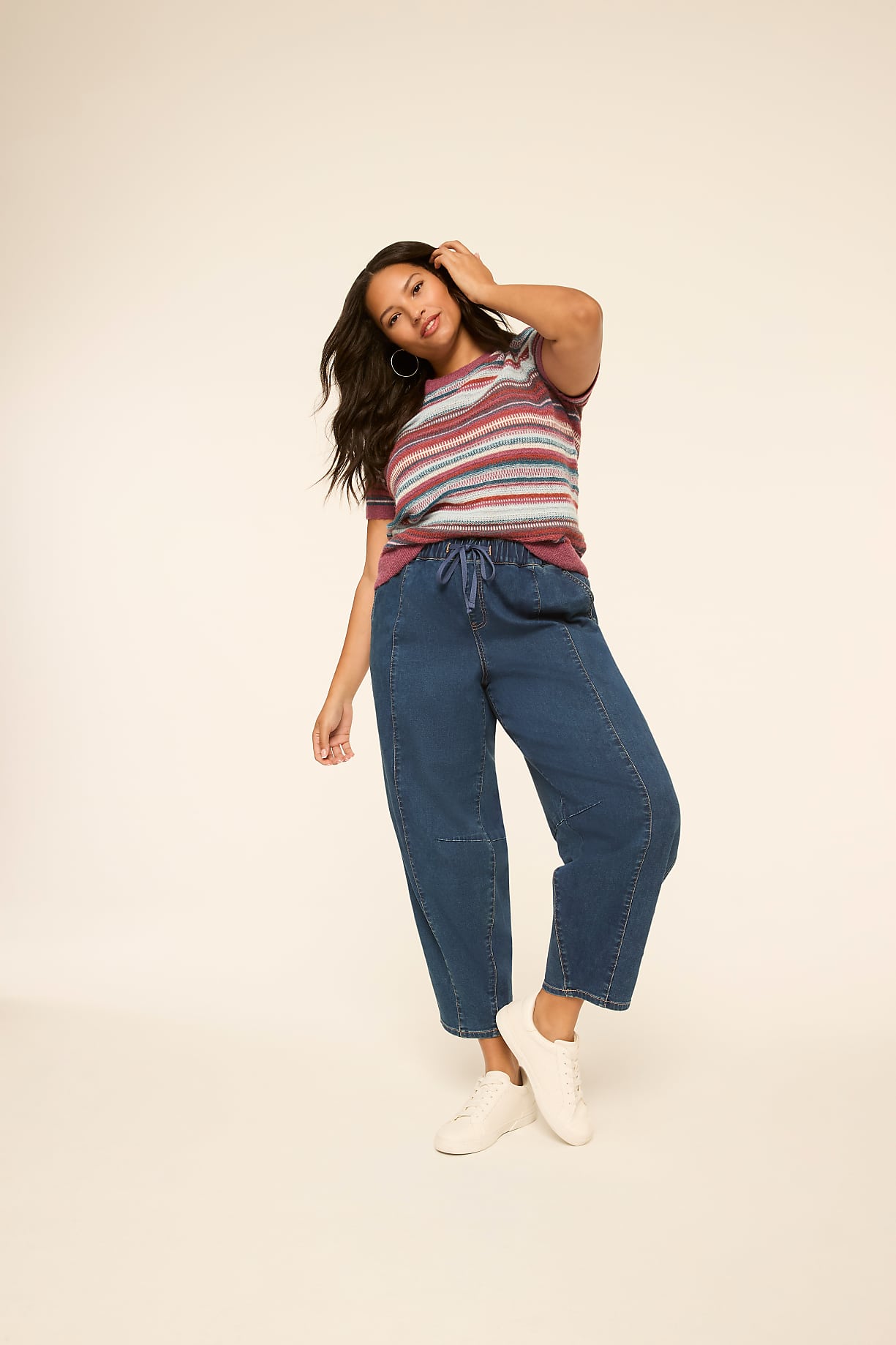 A woman in a striped shirt and wide-leg jeans poses against a plain, light-colored background. Product Image 7