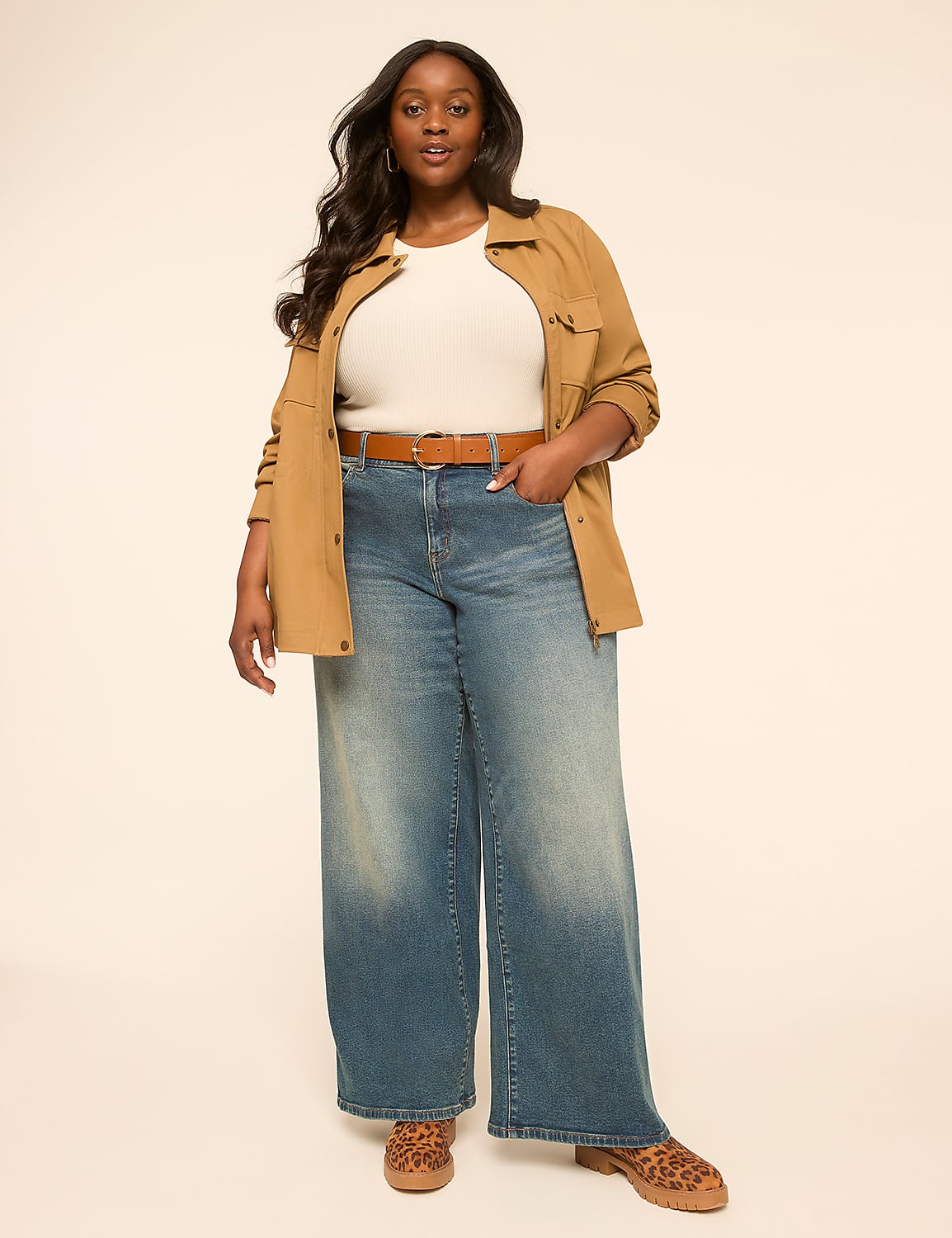 A woman in a white top, brown jacket, and wide-leg jeans stands against a plain, light-colored background. Product Image 3