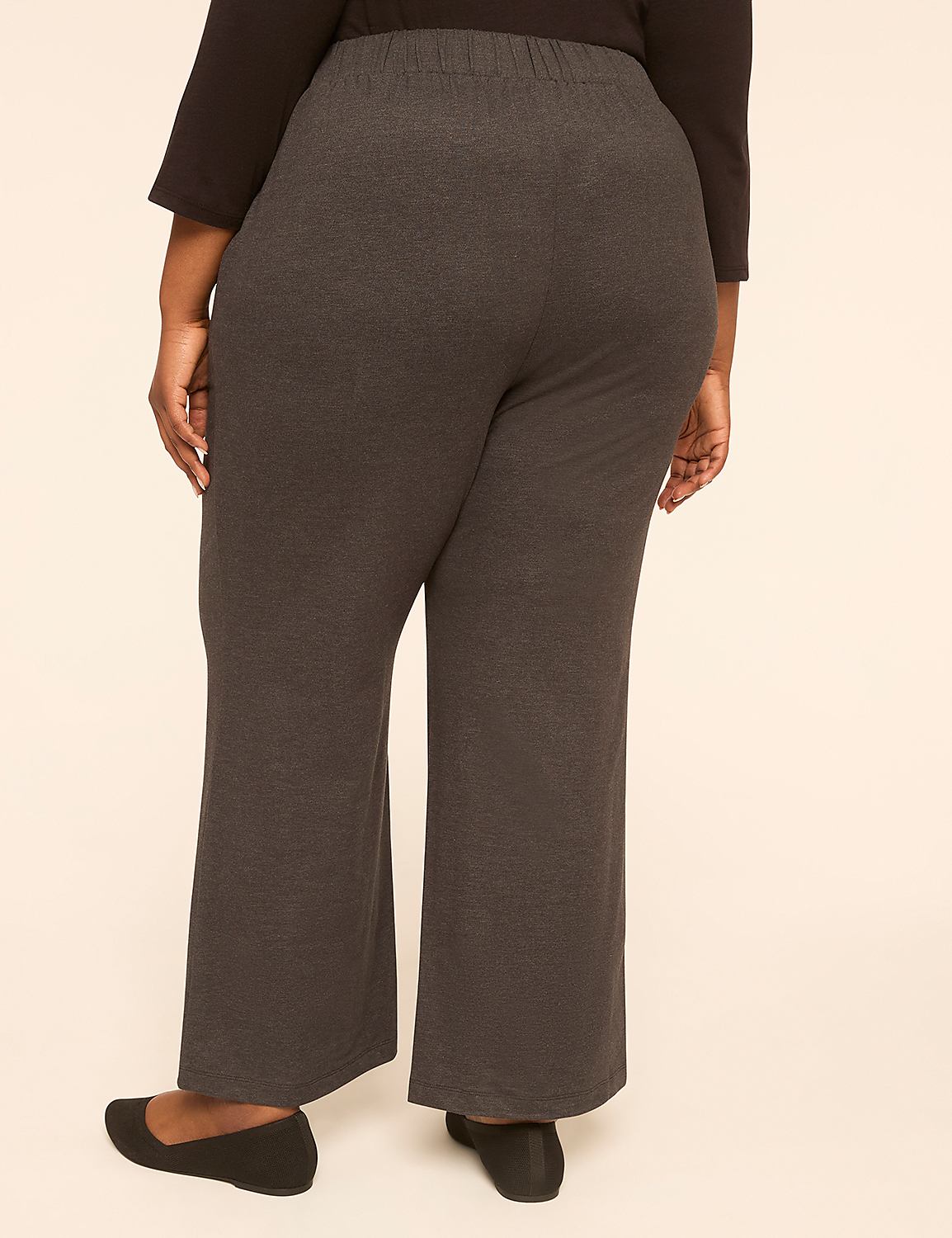 A person wearing dark gray pants and black flats stands against a plain, light-colored background. Product Image 2