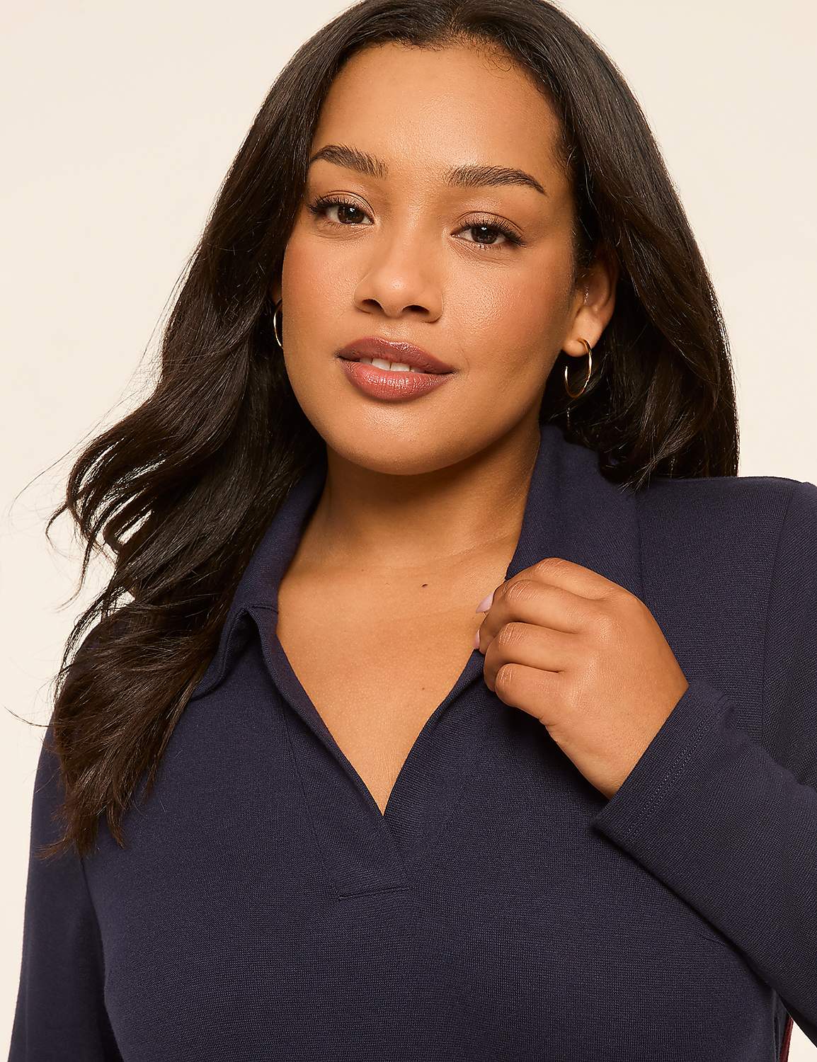 A woman in a navy collared shirt is shown against a plain, light background. Product Image 3