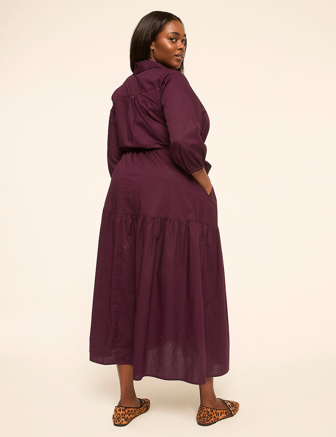 A woman in a purple dress stands against a plain, light-colored background. Product Image 2