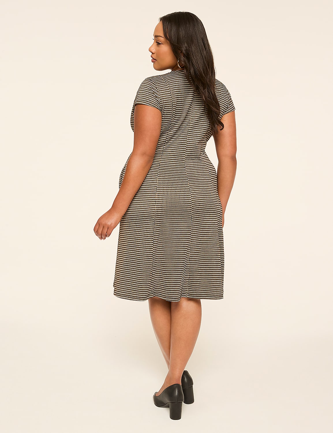 A woman in a striped dress stands against a plain, light-colored background. Product Image 2