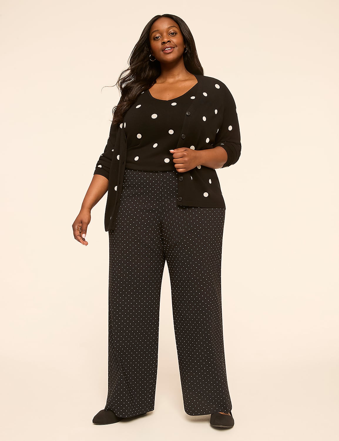 A woman in a polka dot outfit stands against a plain, light-colored background. Product Image 3