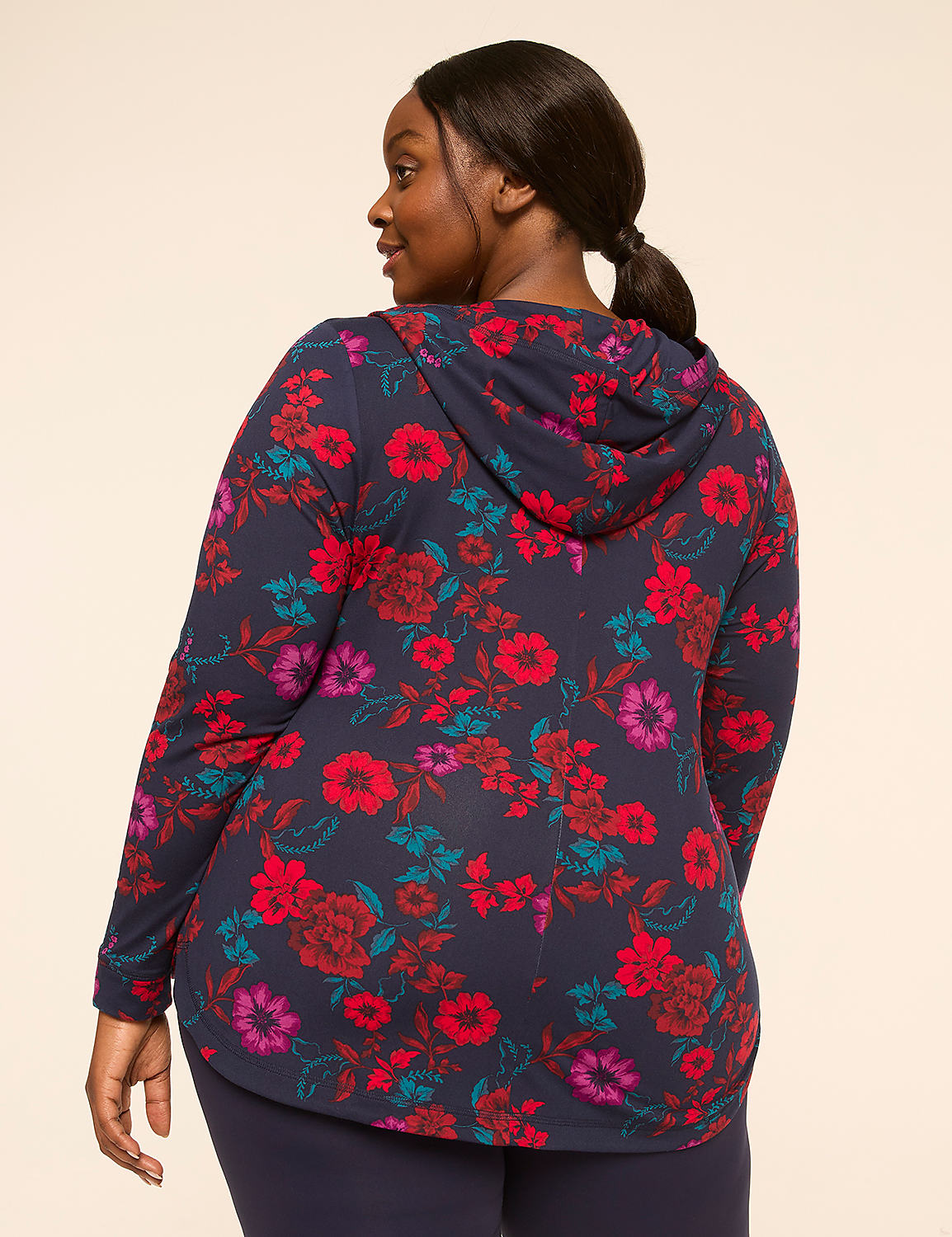 A woman in a floral hoodie and leggings stands against a plain, light-colored background. Product Image 2