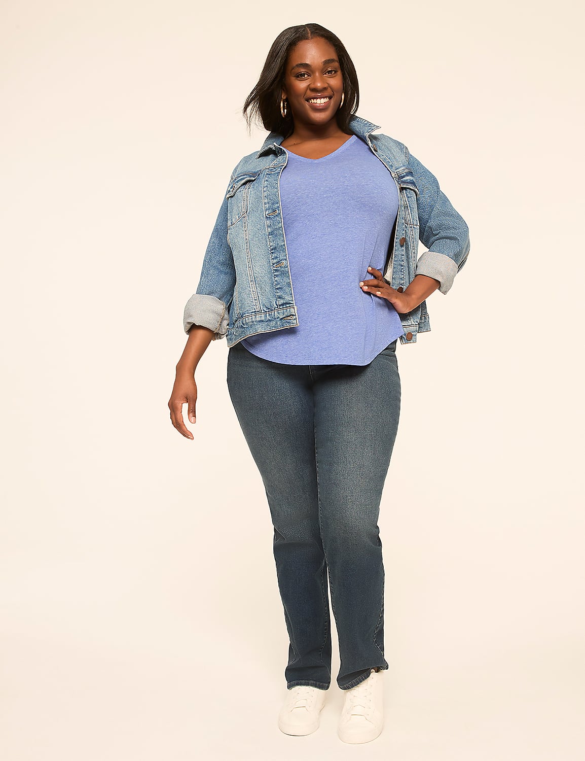 A smiling woman in a denim jacket and jeans stands against a plain, light-colored background. Product Image 3