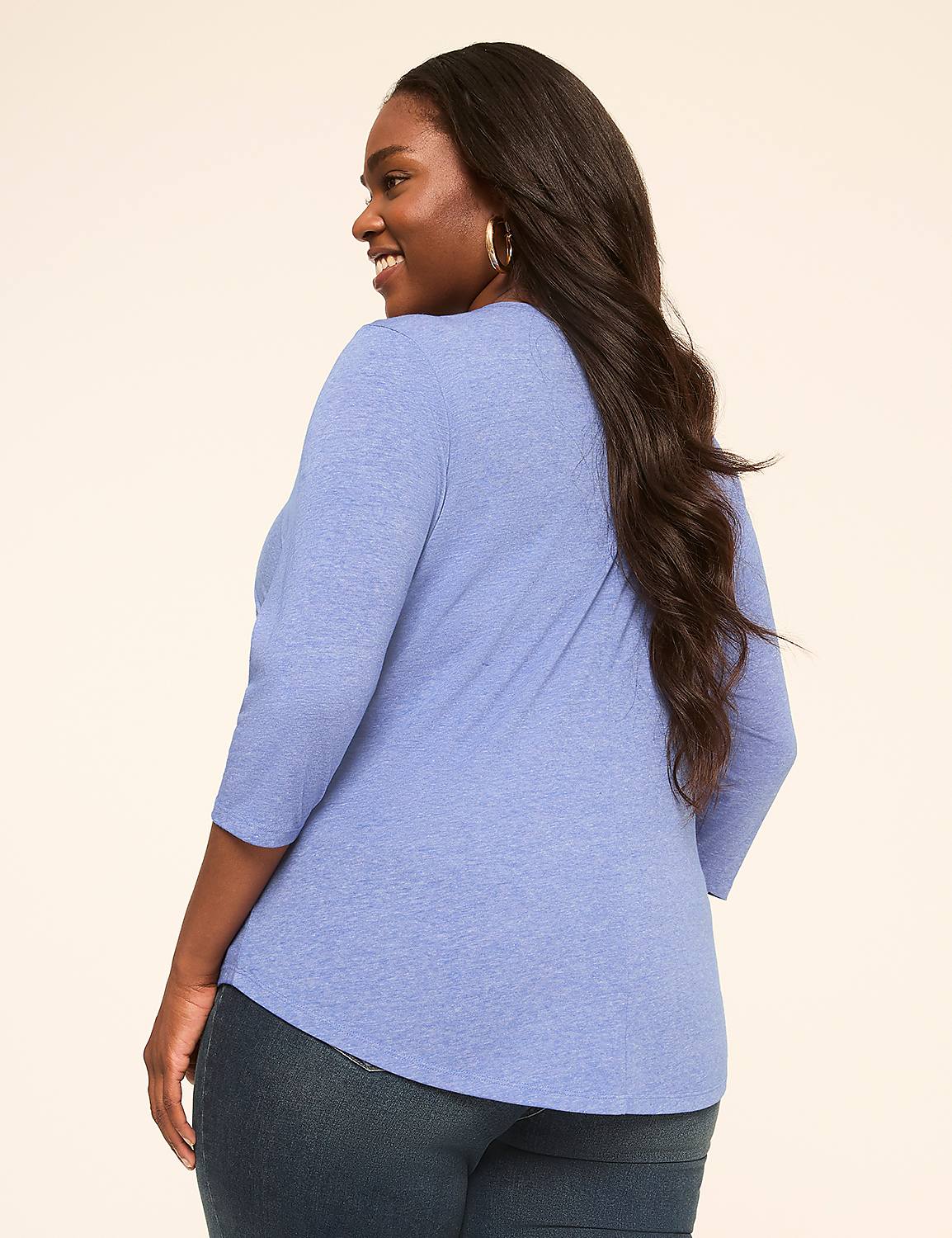 A woman in a blue shirt and jeans stands against a plain, light-colored background. Product Image 2