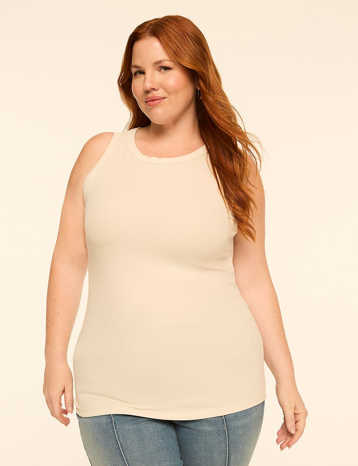 A woman with red hair and a cream-colored ribbed tank top stands against a plain, light-colored background. Product Image 1