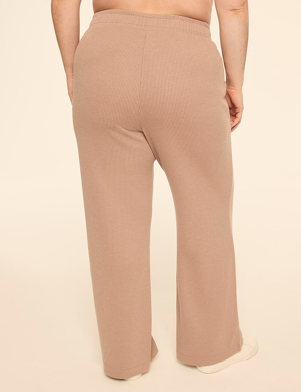 A person wearing tan ribbed lounge pants stands against a plain cream background. Product Image 2