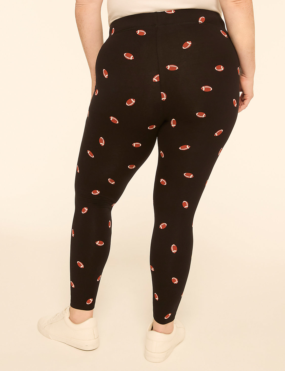 A person wearing black leggings with a football pattern stands against a plain, light-colored background. Product Image 2