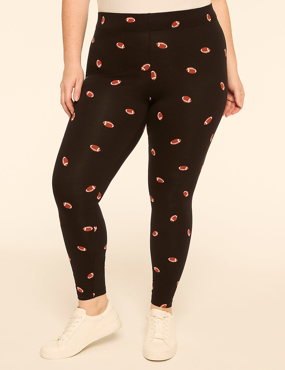 A person wearing black leggings with a football pattern stands against a plain, light-colored background. Product Image 1