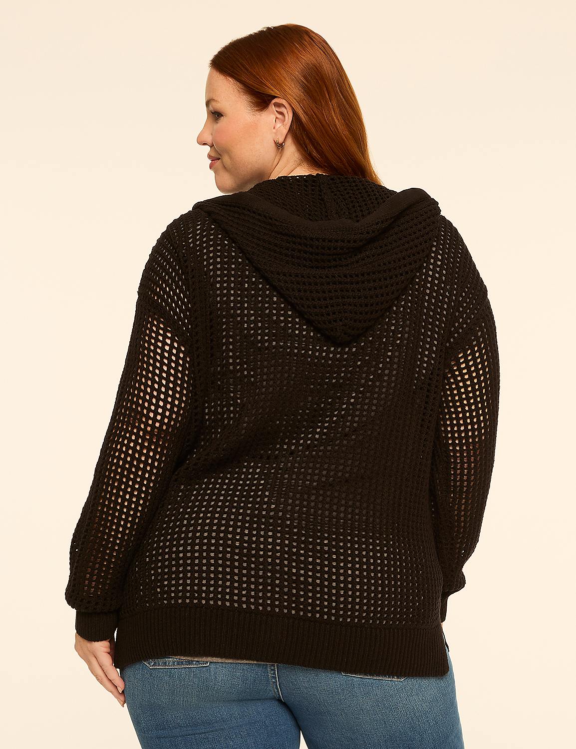 A woman with red hair wearing a black hooded sweater and blue jeans stands against a plain, light-colored background. Product Image 2