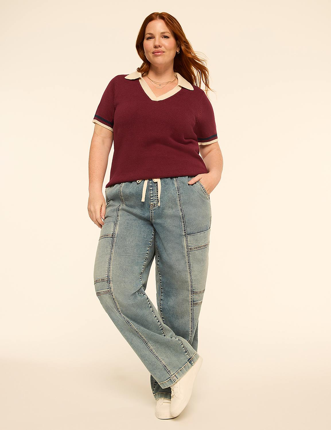 A woman in a maroon collared shirt and light wash jeans stands against a plain, light-colored background. Product Image 3