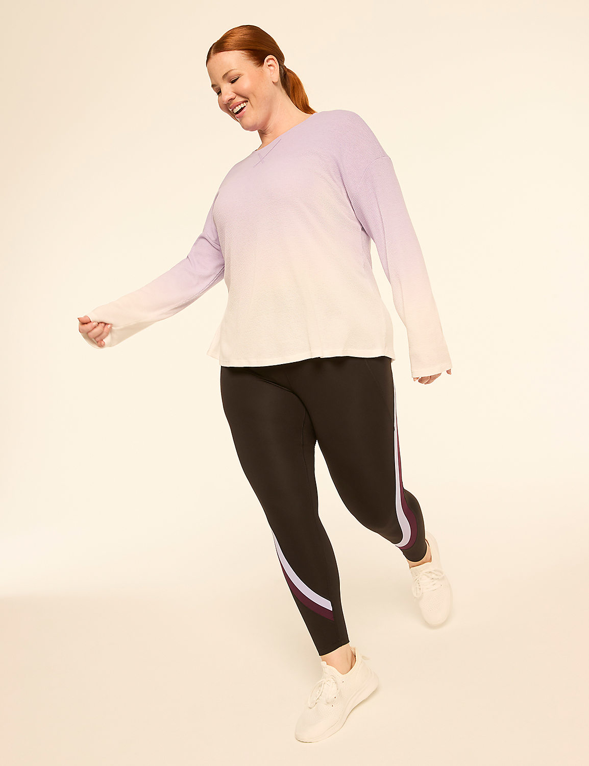A woman in a lavender-to-white ombre top and black leggings with colored stripes on the side poses against a plain, light-colored background. Product Image 3