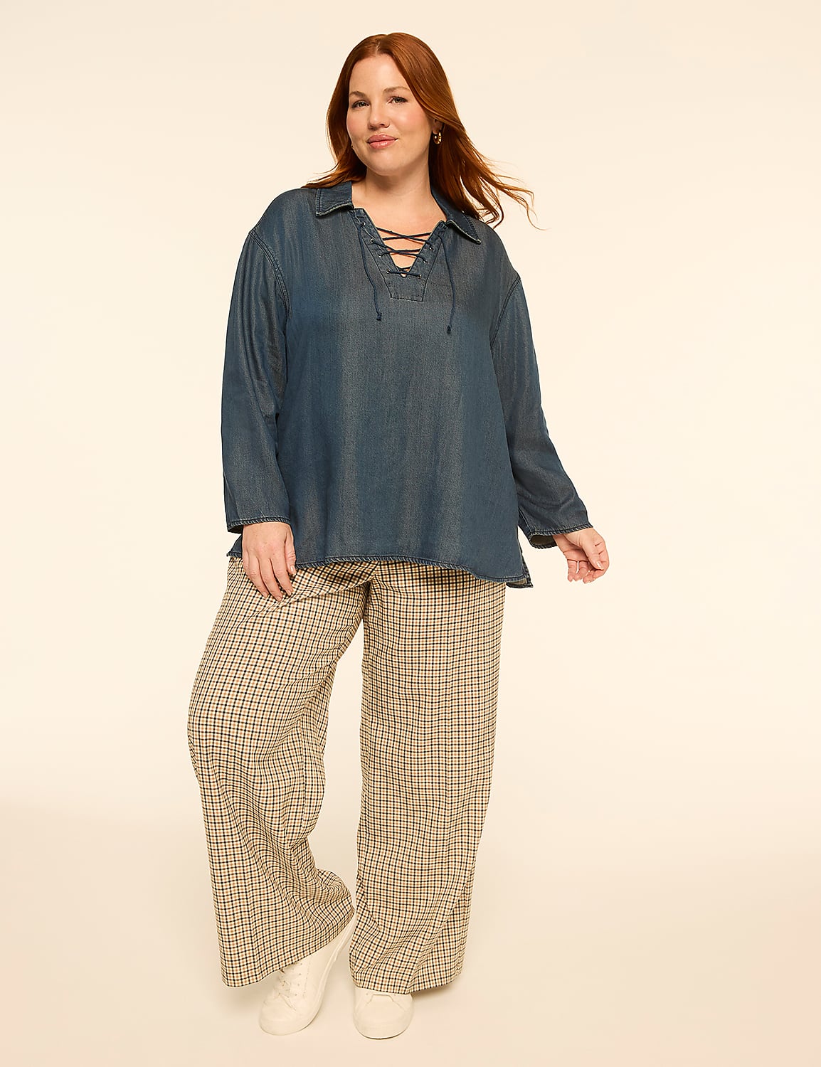 A woman with red hair stands in a denim top and patterned pants against a plain, light-colored background. Product Image 3
