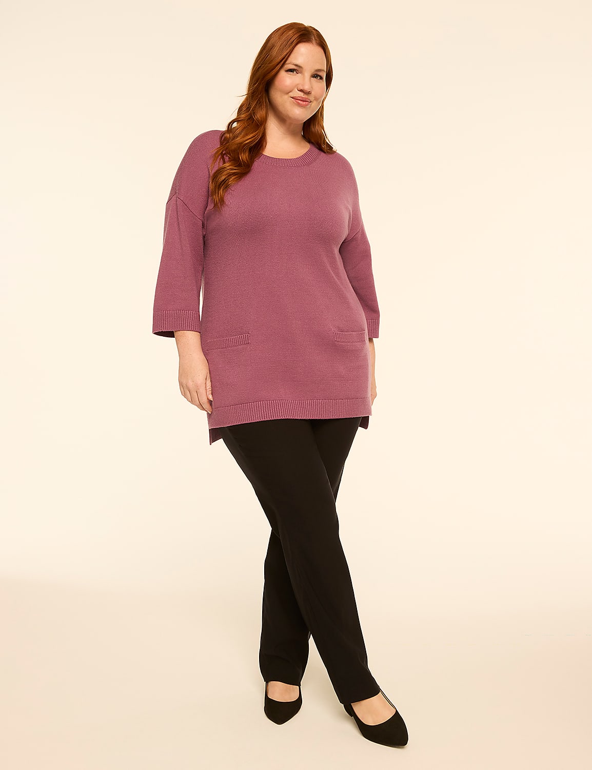 A woman in a mauve tunic and black pants stands against a plain, light-colored background. Product Image 3