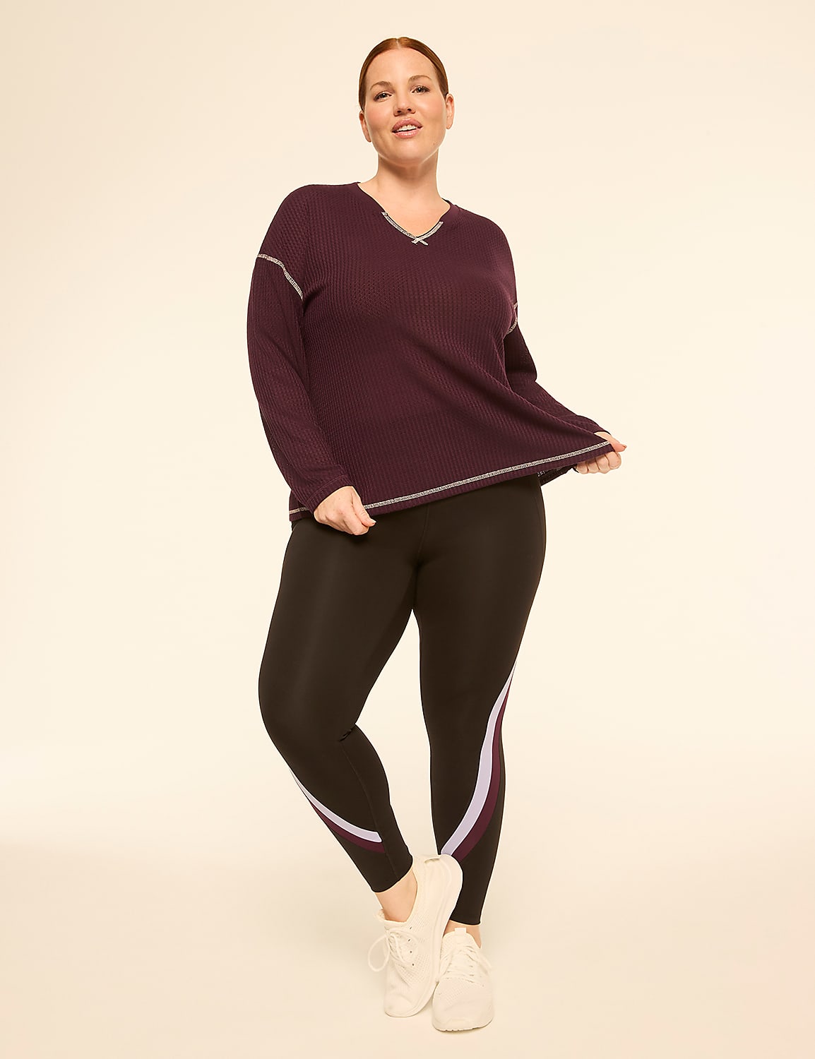 A woman in a purple top and black leggings stands against a plain, light-colored background. Product Image 3