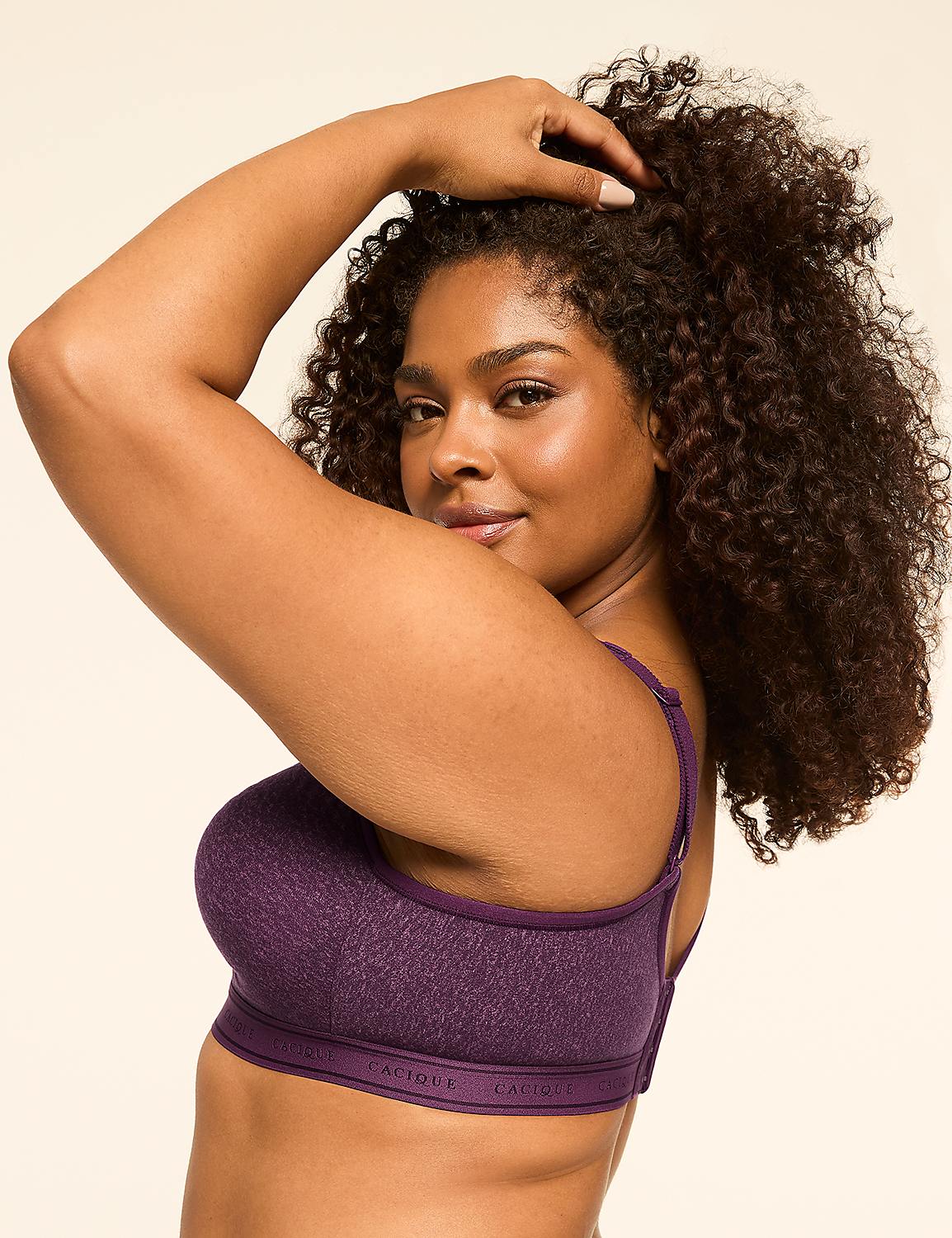 A woman with curly dark hair poses in a purple bra against a plain cream background. Product Image 3