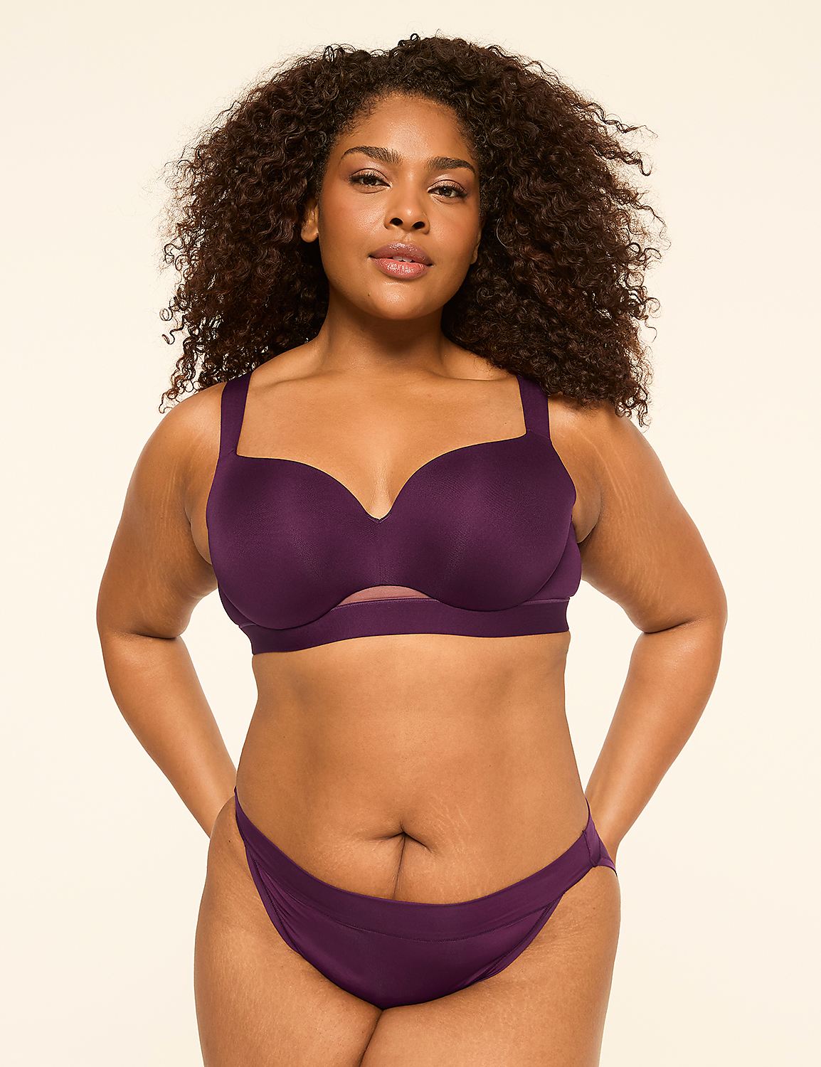 A woman with curly dark hair stands in a purple bra and underwear against a plain, light-colored background. Product Image 4