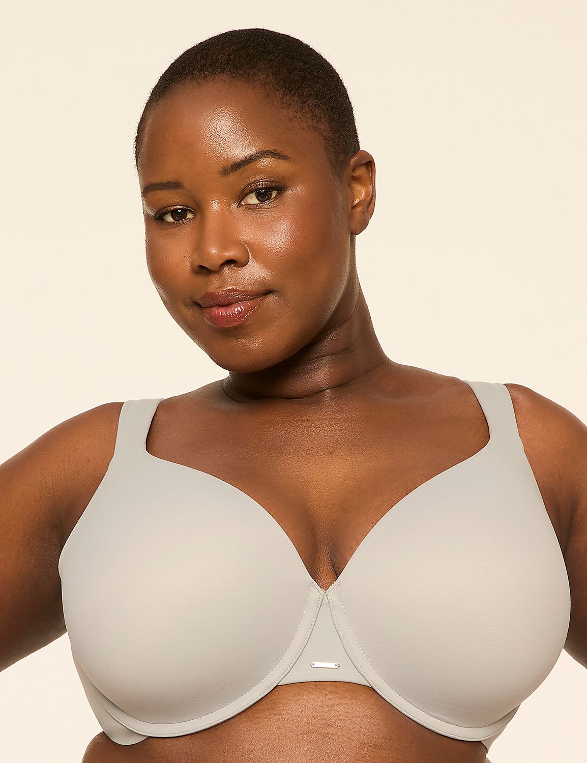 A woman with short hair and a light gray bra is centered against a plain, light background. Product Image 1
