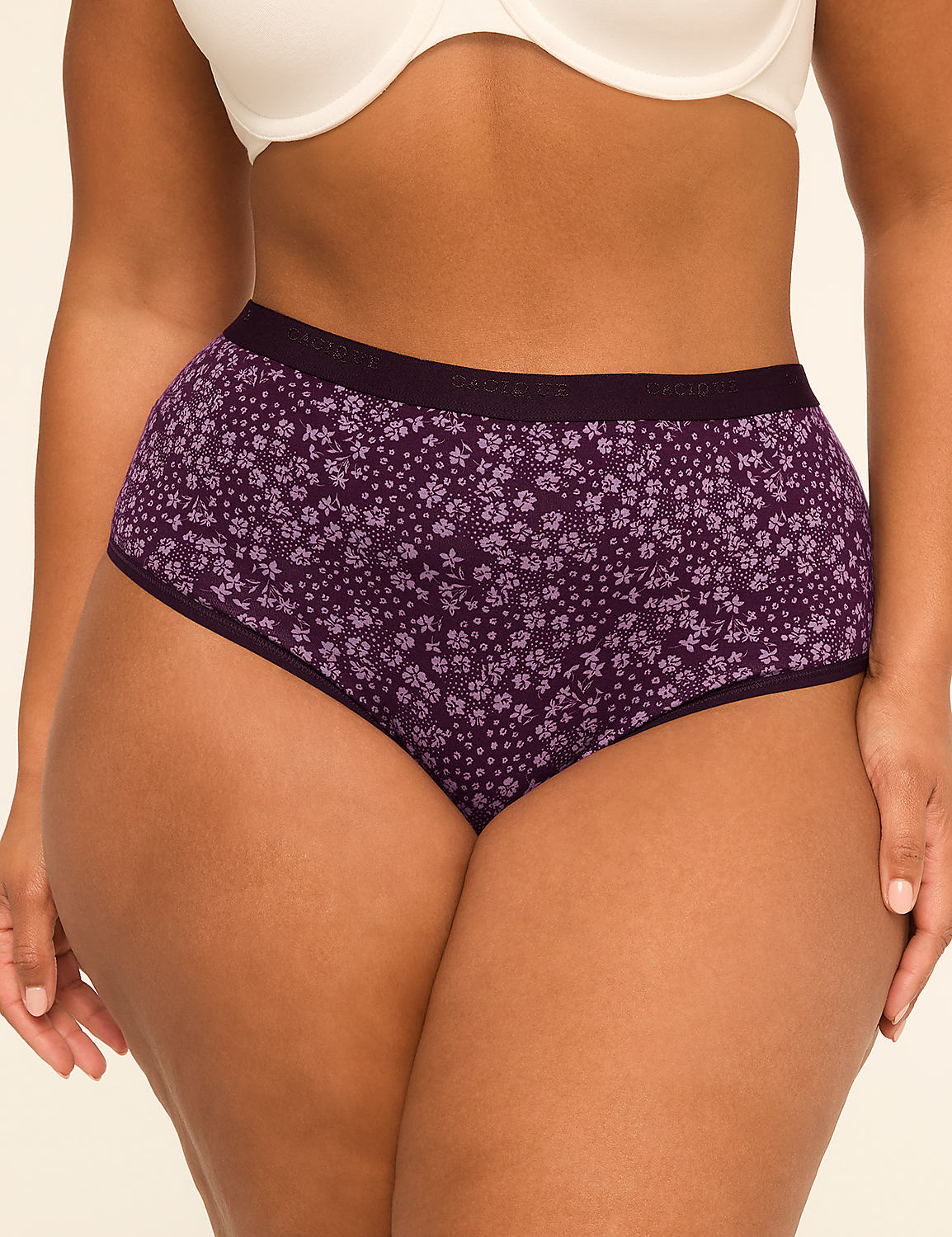 A woman's torso is shown from the waist down, wearing purple floral underwear and a white bra, against a plain background. Product Image 1