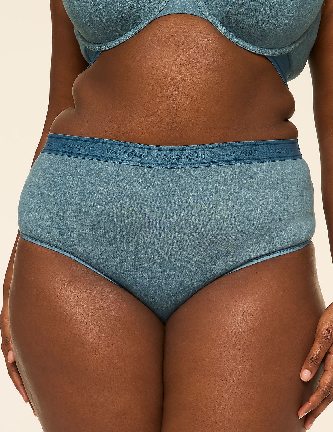 A person wears blue cotton underwear and a matching bra against a plain, light-colored background. Product Image 1