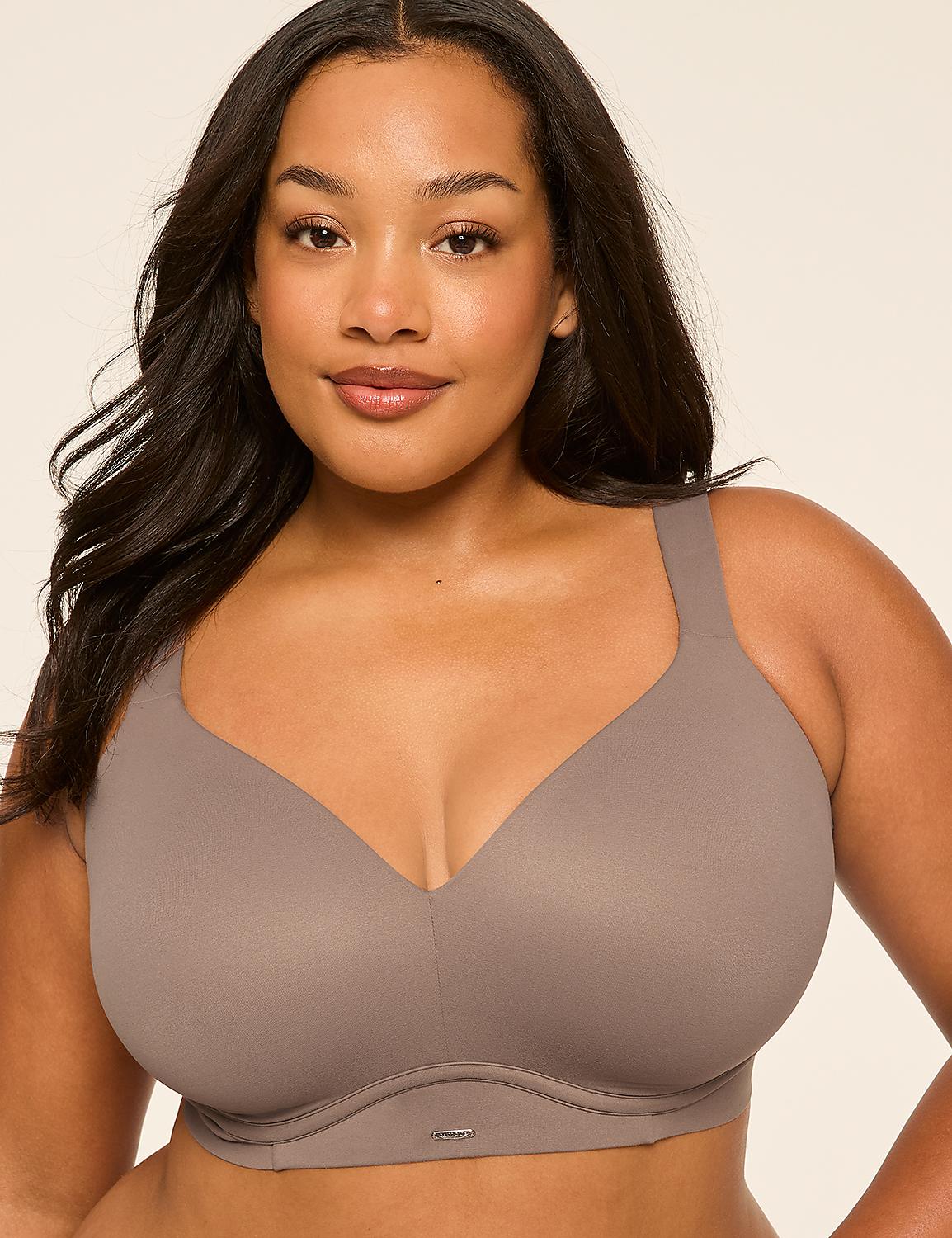 A woman with dark hair and a warm smile wears a taupe bra against a plain, light background. Product Image 1