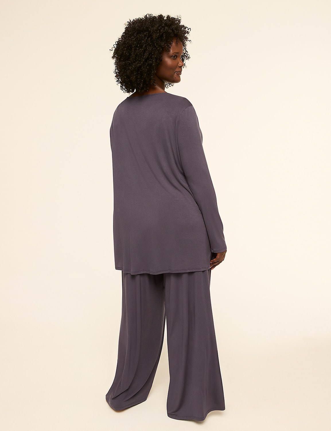 A woman in a purple loungewear set stands against a plain, light-colored background. Product Image 2