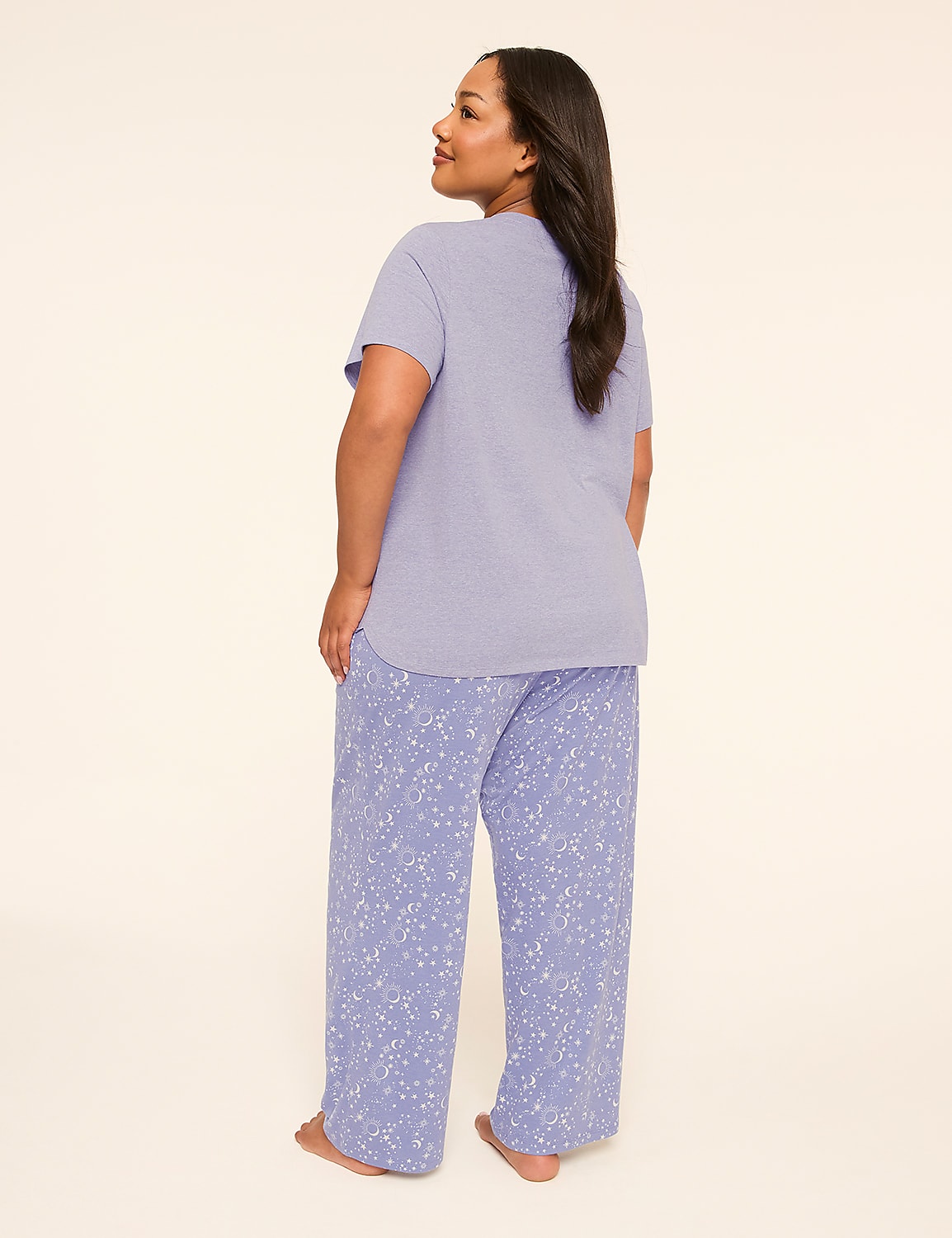 A woman in a light purple t-shirt and patterned pajama pants stands against a plain, light-colored background. Product Image 2