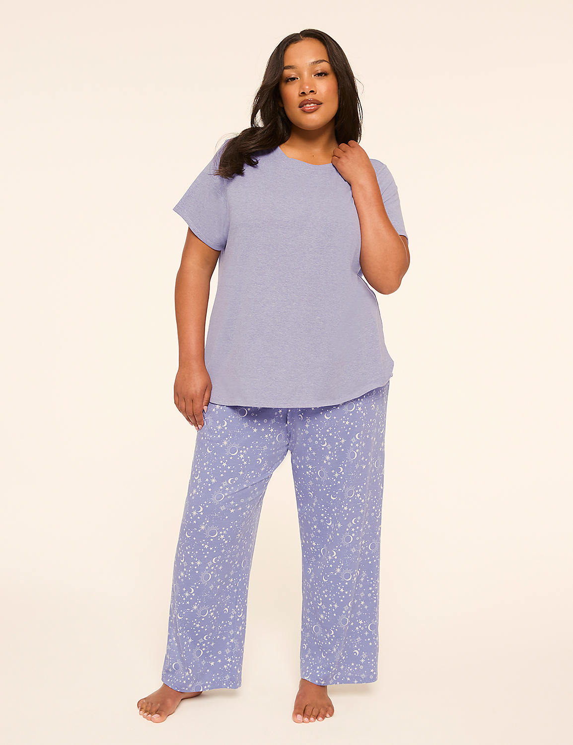 A woman in a light purple textured top and patterned pants stands against a plain, light-colored background. Product Image 1
